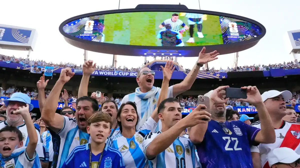 GEMBIRA: Fans Timnas Argentina meluapkan kegembiraannya di tepi lapangan menyaksikan bintang timnas negara tersebut, Lionel Messi, menyarangkan gol 3-0 atas Aljazair.(AP)