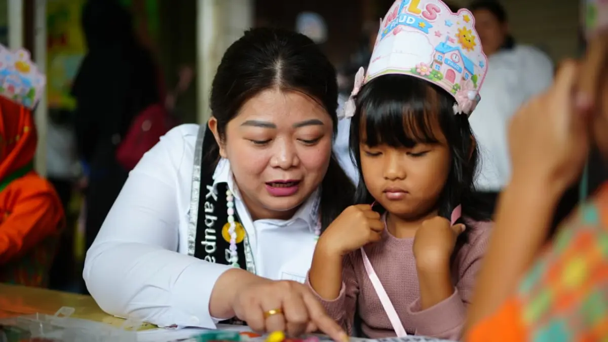 Bupati Mahulu Angela Idang Belawan bercengkrama dengan anak-anak saat monitor dan evaluasi ke TK Merpati, Rabu (22/7). (JODY KRISTIANTO/KP)