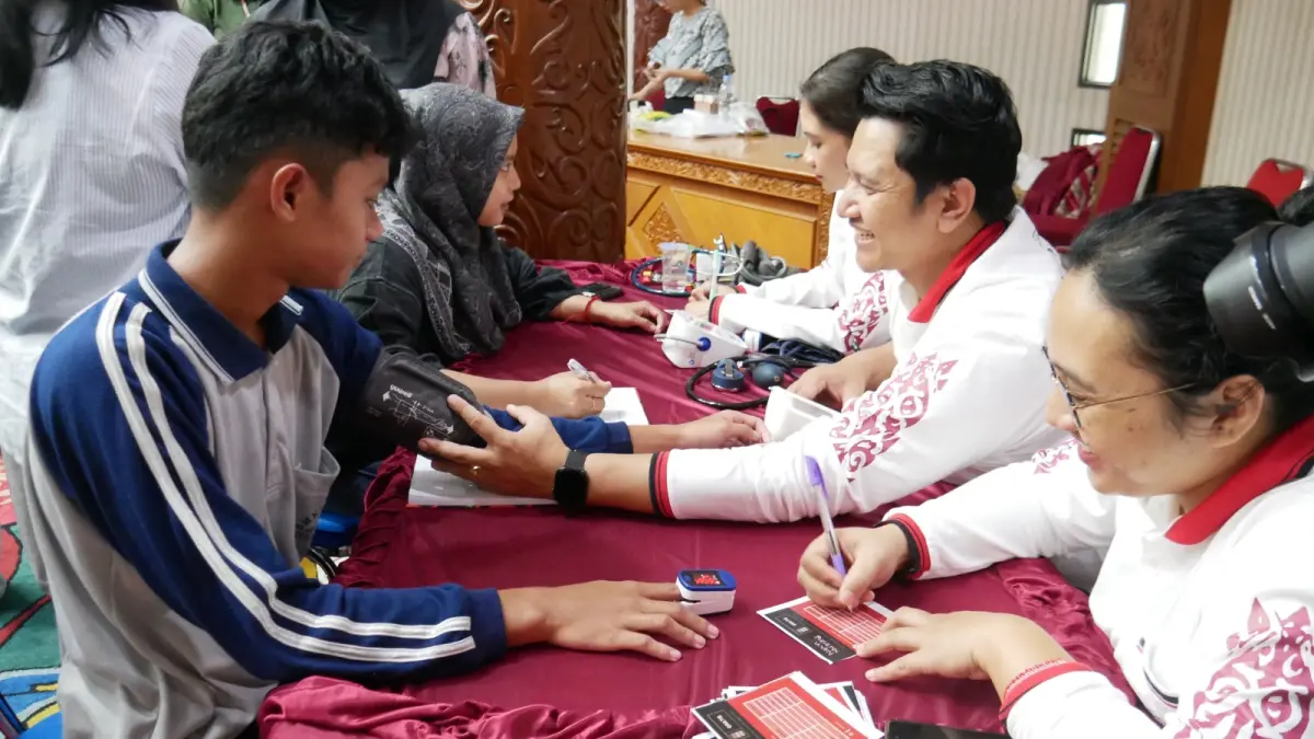 DETEKSI DINI : Petugas kesehatan YJI Kutai Barat saat melakukan pengecekan tekanan darah kepada salah seorang pelajar. (IST)