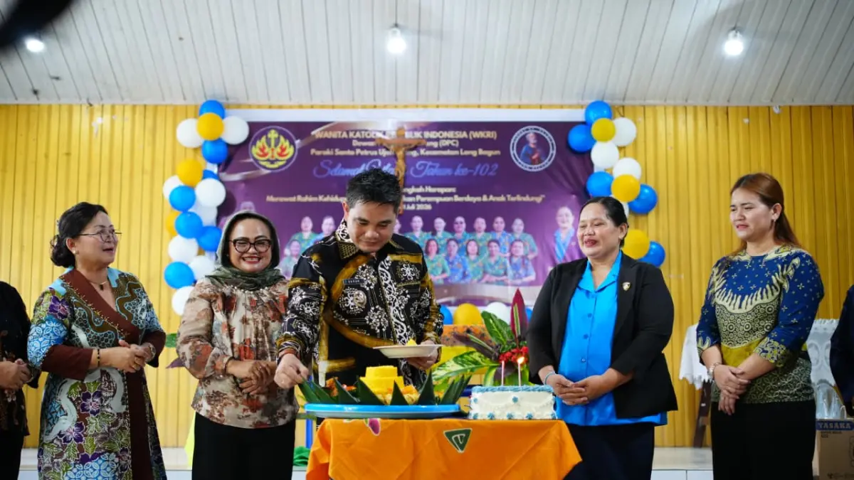 PERAN PEREMPUAN: Wakil Bupati Suhuk memotong tumpeng pada peringatan HUT ke-102 WKRI di Paroki Santo Petrus Ujoh Bilang, Jumat (31/7). (JODY KRISTIANTO/KP)
