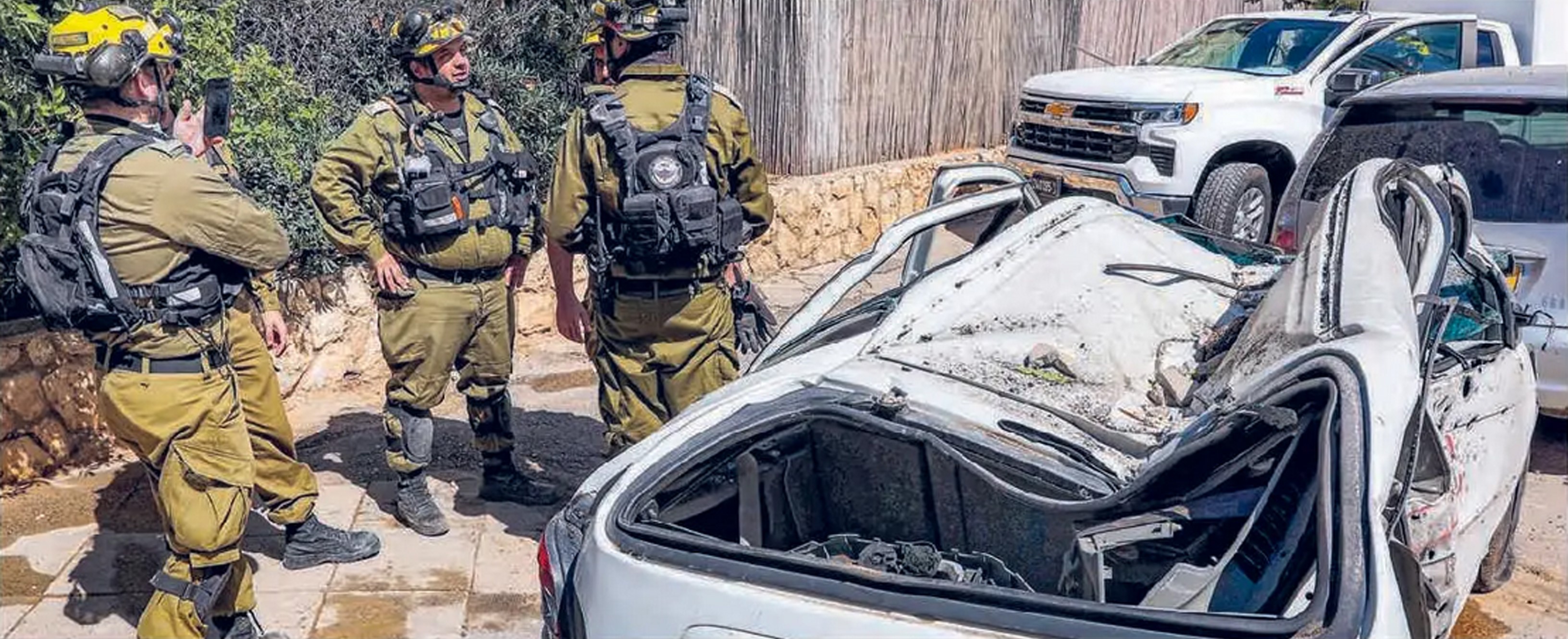 JEJAK GEMPURAN: Pasukan Israel mengecek kendaraan yang hancur karena serangan Iran di Bat Yam, bagian selatan Tel Aviv (9/3).