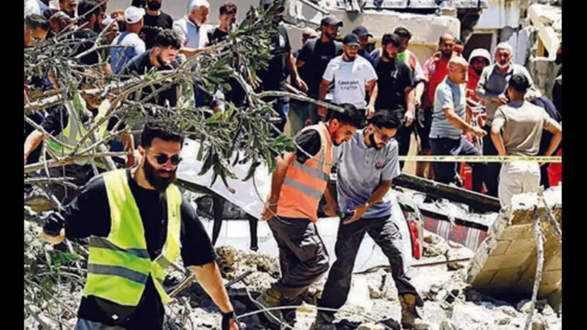 ULUH LANTAK: Petugas mengevakuasi jenazah dari lokasi serangan udara Israel yang menargetkan Desa Qannarit di Lebanon selatan pada Sabtu (20/6). (Foto: AFP)