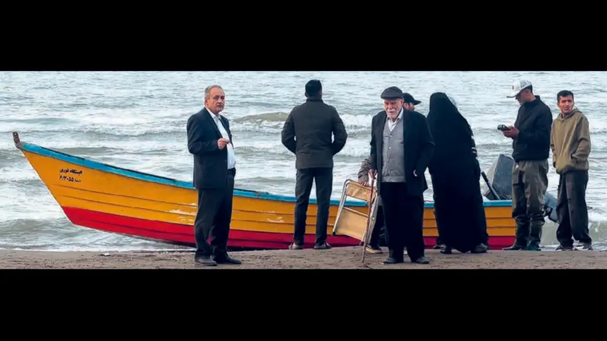 MENEPI: Sejumlah orang berdiri di tepi pantai Laut Kaspia, Iran utara. Seorang pelaut Iran tewas akibat serangan Ukraina, Sabtu (25/7). (Foto: ATTA KENARE / AFP)