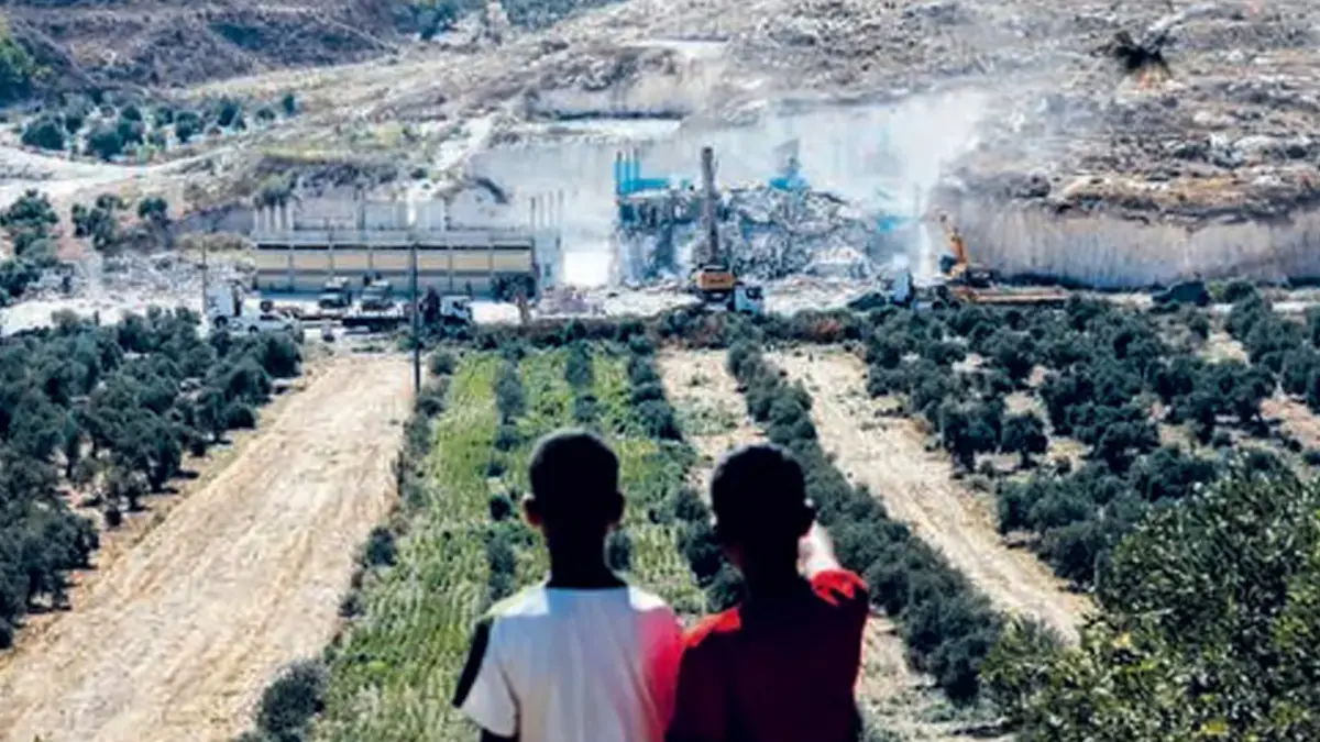 HANCUR: Anak-anak Palestina menyaksikan pasukan Israel membongkar toko dan apartemen di Kota Jenin, Palestina, wilayah Tepi Barat yang diduduki Israel, Senin (27/7). (Foto: MOHAMMAD MANSOUR/AFP)