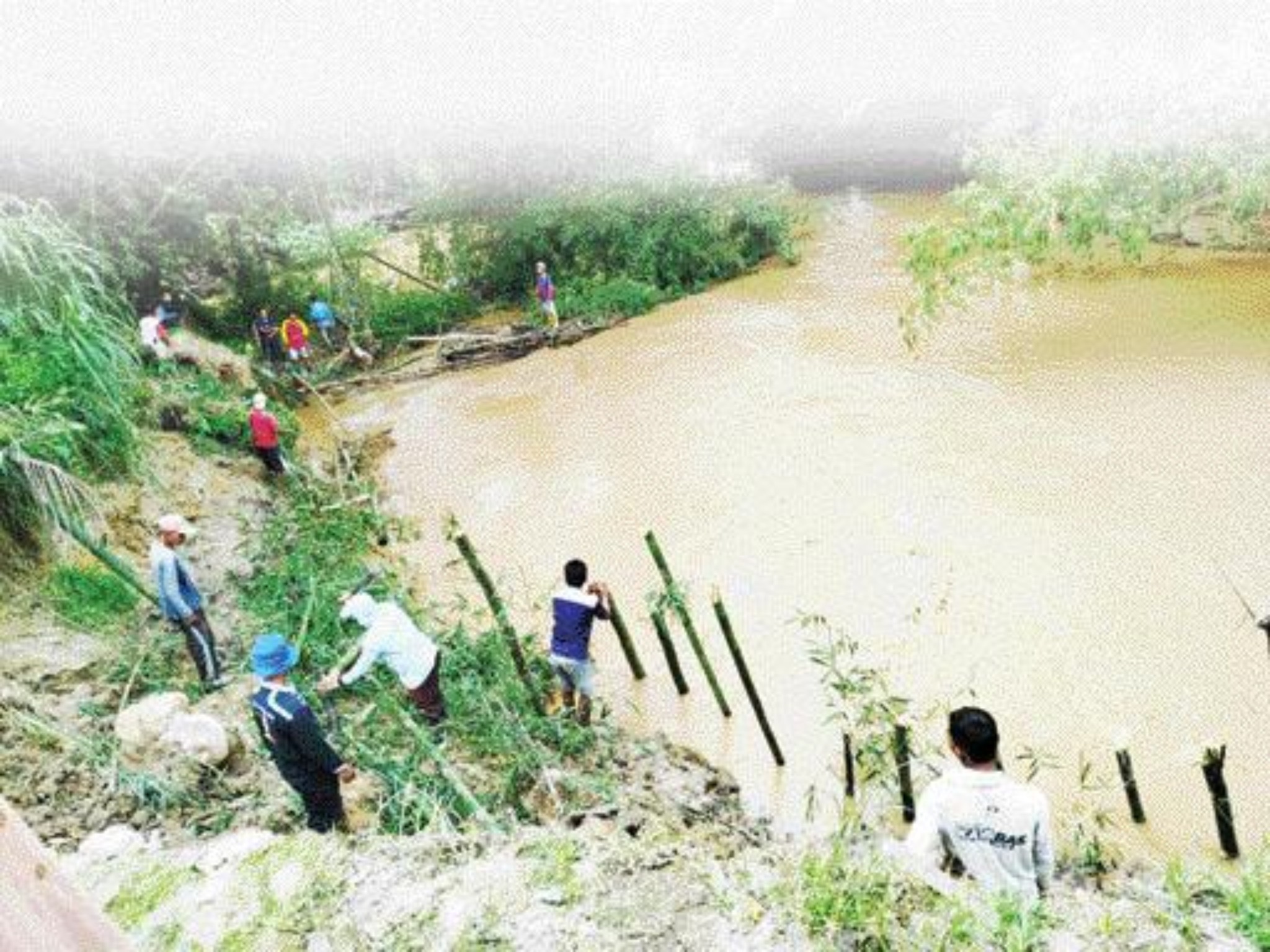 ANTISIPASI: Warga Koto Baru Silanggang, Kecamatan Payakumbuh melakukan antisipasi sederhana untuk menahan tebing di pinggir aliran sungai yang tergerus air, Senin (27/5).(HENDRI UNTUK PADEK)