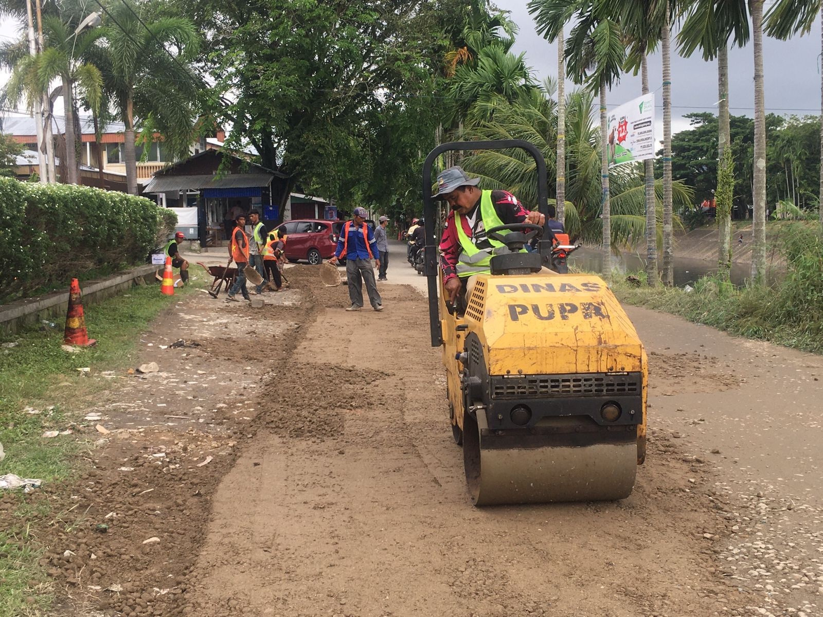 Petugas sedang memperbaiki Jalan Banjir Kanal Timur Alai Parak Kopi, beberapa waktu lalu. (SILVINA/PADEK)