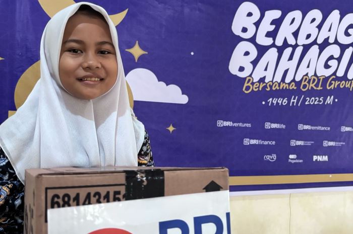 Salah seorang anak di Yayasan Pembinaan Anak Cacat (YPAC) Kota Padang saat menerima bingkisan lebaran dari BRI RO Padang.
