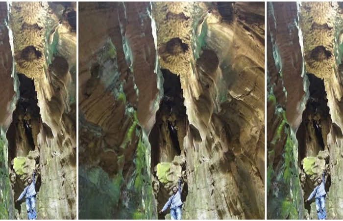Seorang pengunjung sedang berfoto di dalam Goa Batu Kapal. (ARDI/PADEKS)