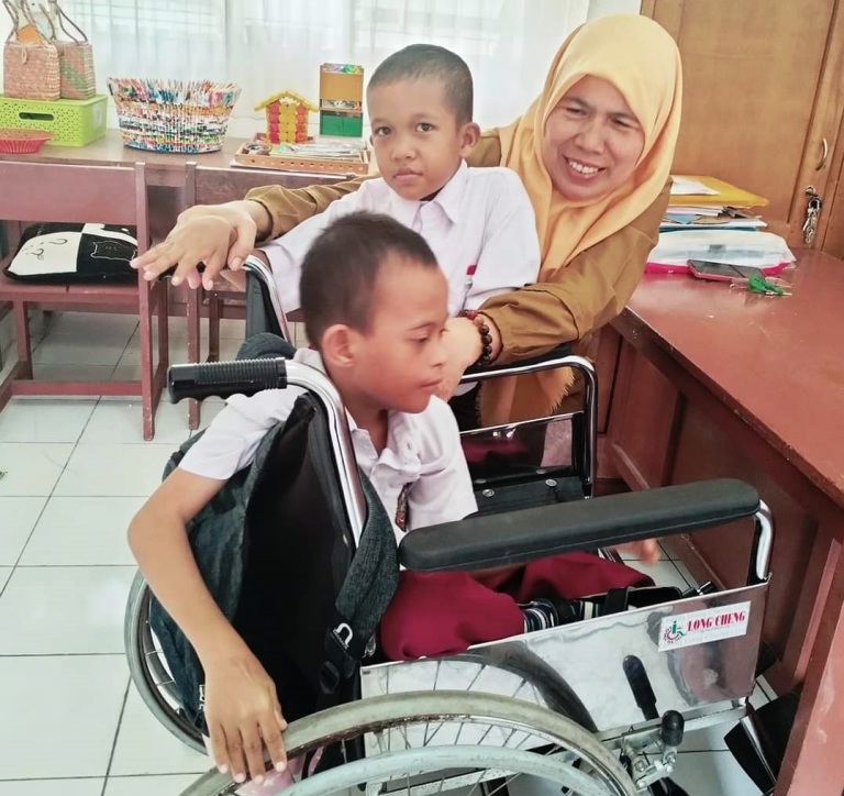 DUKUNGAN: Penulis saat bersama dua orang murid berkebutuhan khusus SLBN 1 Kota Padang.(TIM LAMAN GUR)