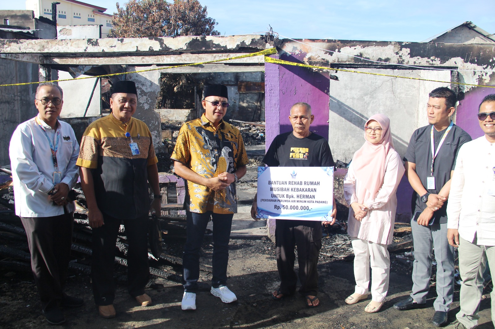 Dirut Perumda Air Minum Kota Padang, Hendra Pebrizal didampingi sejumlah menejer menyerahkan bantuan Rp 50 juta kepada mantan karyawan yang jadi korban kebakaran, Jumat (11/7).