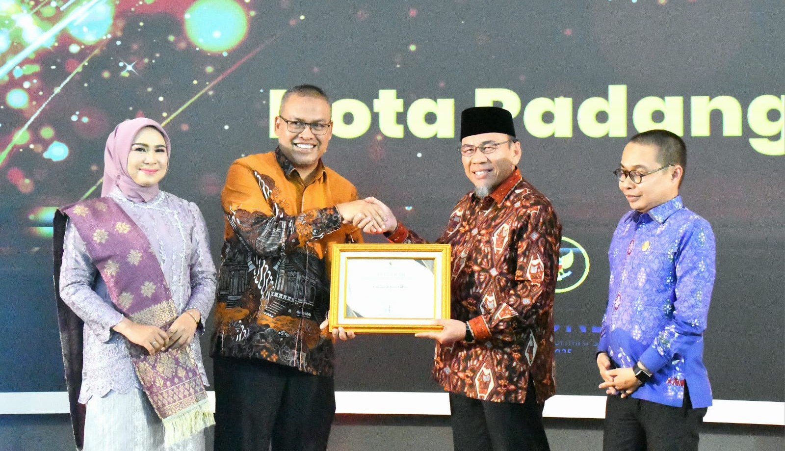 Wakil Wali Kota Padang Maigus Nasir menerima piagam penghargaan prediket Kota Informatif dari Sekdaprov Sumbar, Arry Yuswandi.