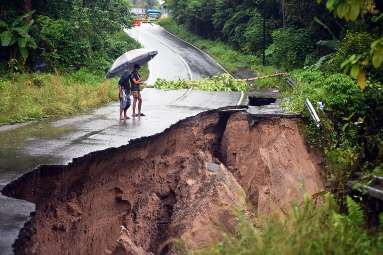 DITUTUP SEMENTARA: Warga melihat kondisi jalan longsor di Nagari Paritmalintang, Kabupaten Padangpariaman, Sabtu (22/11).