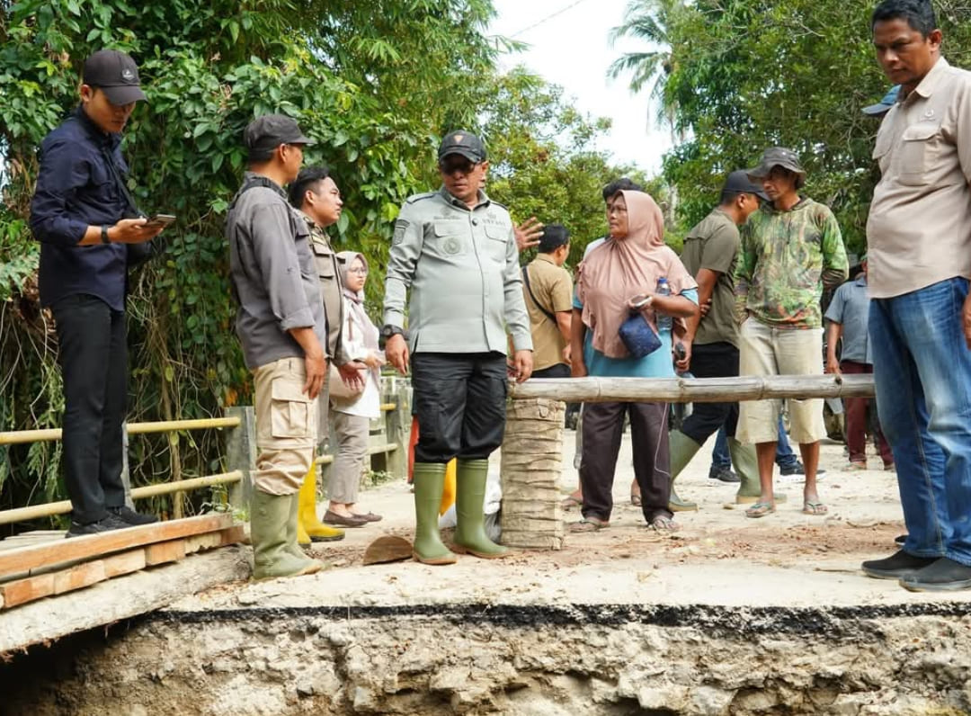 Bupati Eka Putra meninjau pengerjaan jembatan sementara di Jorong Baiang untuk membuka kembali akses warga yang terisolir.(Foto: Prokopim)