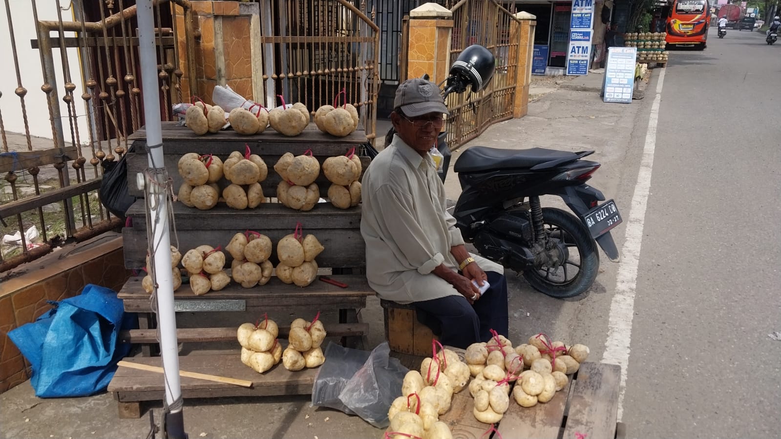 Pedagang bengkoang di Lubuk Begalung bertahan berjualan meski pendapatan menurun, mengandalkan pembeli luar kota dan tetap mengutamakan pendidikan anaknya. (Foto: Mengki K/Padeks)