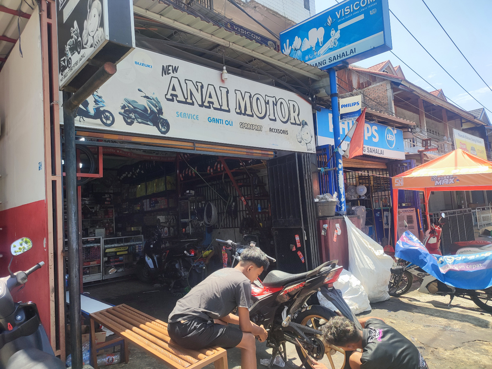 Salah seorang montir sedang memperbaiki motor pelanggan di salah satu bengkel di kawasan Parupuktabing, kemarin.