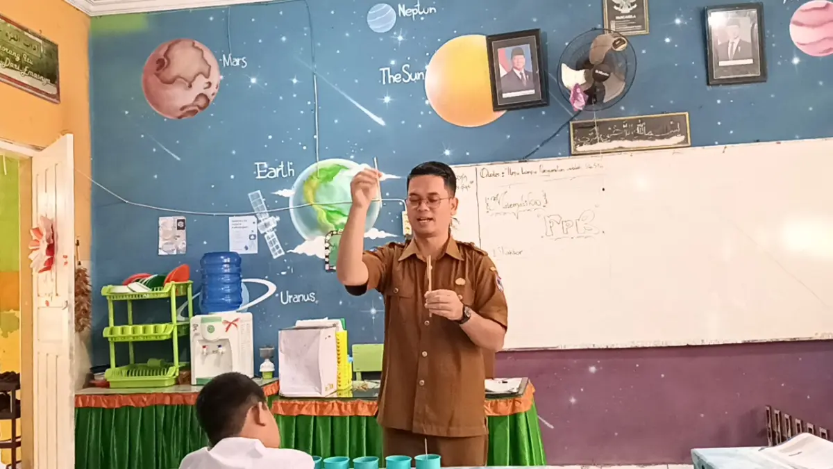 Guru SDN 21 Payakumbuh Syafrianto Rajo Mudo, S.Pd, Gr saat memberikan materi pelajaran di depan kelas beberapa waktu lalu. (TIM LAMAN GURU)