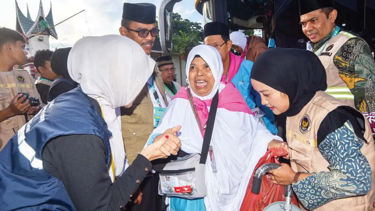 Petugas membantu calon haji lansia Embarkasi Padang turun dari bus saat tiba di Asrama Haji Tabing, Padang, Kamis (23/4). Sebanyak 386 calon haji kelompok terbang (kloter) pertama asal Padang akan diberangkatkan menuju Arab Saudi melalui Bandara Internasional Minangkabau (BIM) pada Jumat (24/4) dini hari. (FITRA YOGI/ANTARA FOTO)
