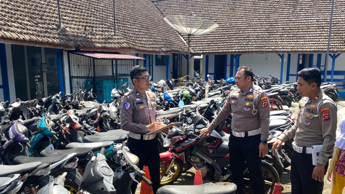 Kasat Lantas Polres Payakumbuh, Iptu Andi F. Purna, memeriksa salah satu sepeda motor hasil penindakan pelanggaran lalu lintas dan razia balap liar yang hingga kini belum dijemput pemiliknya di Mapolres Payakumbuh, Kamis (4/6). (SY RIDWAN/PADEK)