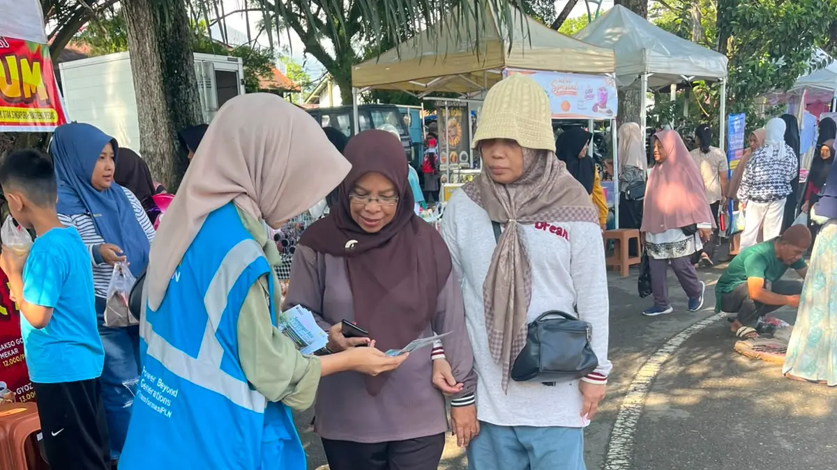 Petugas PT PLN UP3 Bukittinggi memberikan edukasi kepada masyarakat mengenai Promo Tematik Tambah Daya "Semangat Baru Makin Berdaya" saat kegiatan Jalan Santai di Lapangan Kantin Bukittinggi, Minggu (19/7/2026).