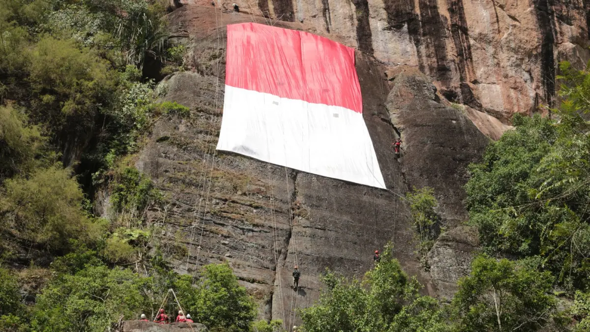 Sang Saka Merah Putih berukuran 15 x 25 meter dibentangkan di tebing Taman Wisata Lembah Harau, Kabupaten Limapuluh Kota, Senin (17/8/2026), pada ketinggian 107 meter untuk memperingati HUT ke-81 Kemerdekaan RI. Aksi itu dipelopori FPTI Sumbar bersama sejumlah unsur dan komunitas.