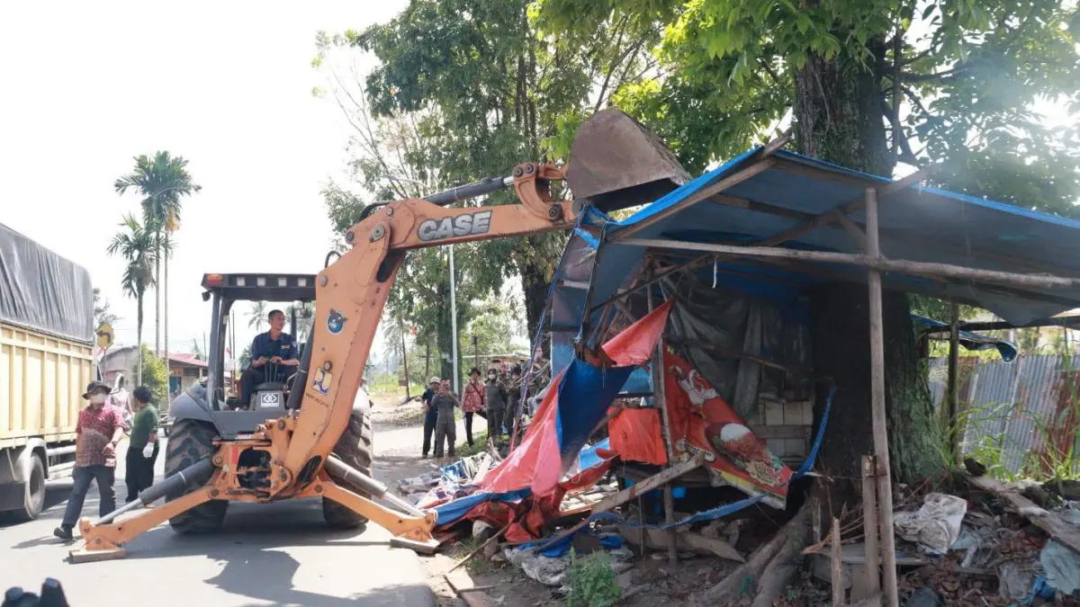 Petugas menggunakan alat berat untuk membongkar bangunan dalam penertiban di kawasan Batang Agam dan Jalan Imam Bonjol, Kota Payakumbuh.
