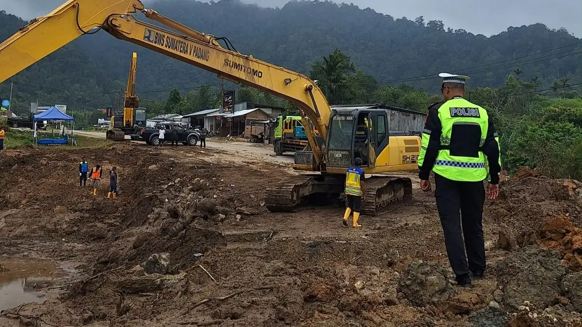Kasat Lantas Polres Solok Iptu Akbar Kharisma Tanjung meninjau penanganan sisa material longsor di Jalan Baru Kayu Aro, Sabtu (26/9/2026).