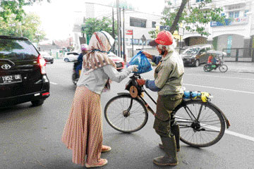 Aksi Komunitas Ramadhan Berbagi saat membagikan paket sembako kepada masyarakat yang terdampak Covid-19. (IST)