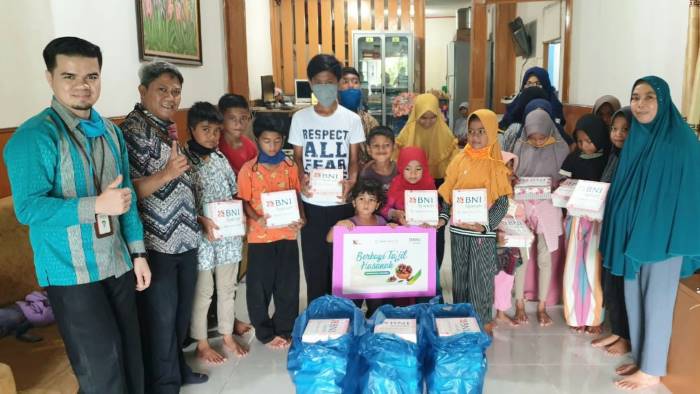 Branch Manager BNI Syariah Padang Heru Mulyadi (dua dari kiri) saat membagikan takjil di panti asuhan. (Foto: IST)