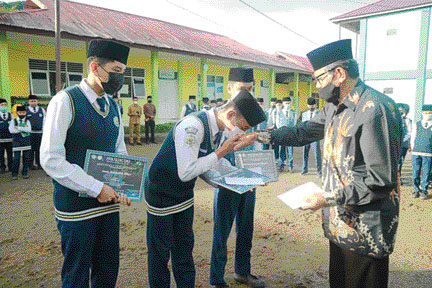 APRESIASI: Ketua Yayasan Pembangunan Daerah (Bangda) Padangpanjang Rizal Hidayat menyerahkan bonus kepada Imam dkk atas prestasi lomba Fahmil Quran di Padang.(IST)