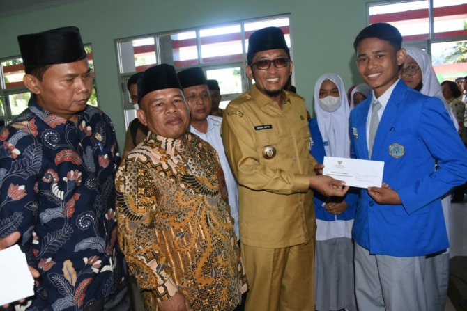 BANTUAN: Wako Hendri Septa menyerahkan bantuan beasiswa kepada siswa SMK SMAK Padang, Senin (22/8). (IST)