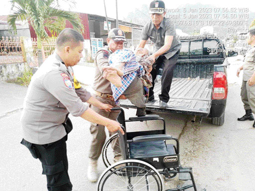 BERJIBAKU: Petugas gabungan mengevakuasi lansia yang tidur di dalam gorong-gorong di Kelurahan Mataair, Kecamatan Padang Selatan, kemarin.(IST)