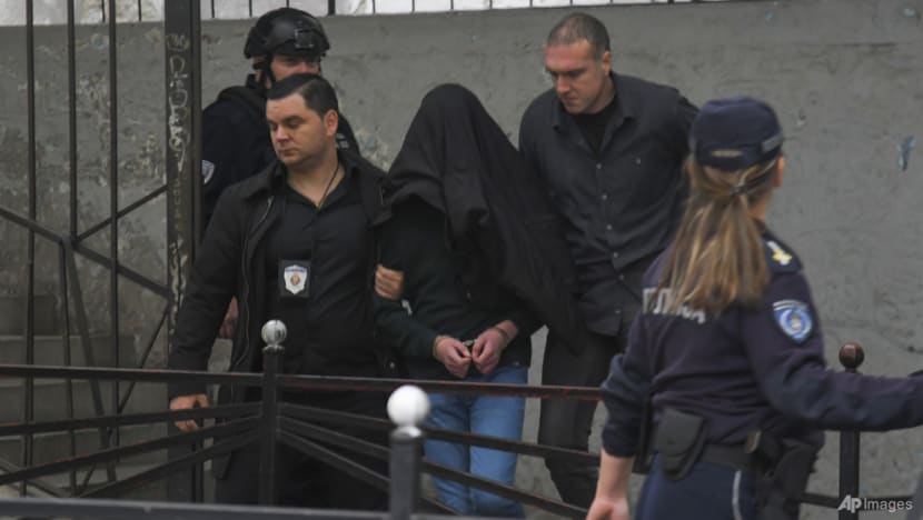 Seorang tersangka dibawa polisi di luar sekolah Vladislav Ribnikar di Beograd, Serbia, Rabu, 3 Mei 2023. (Foto: AP)