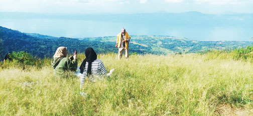 SEJUMLAH pengunjung sedang menikmati suasana di hamparan rumput Puncak Gagoan.(FRIKEL ADILA M/PADEK)