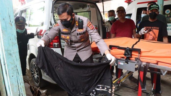 EVAKUASI: Petugas kepolisian melakukan evakuasi terhadap jenazah korban.