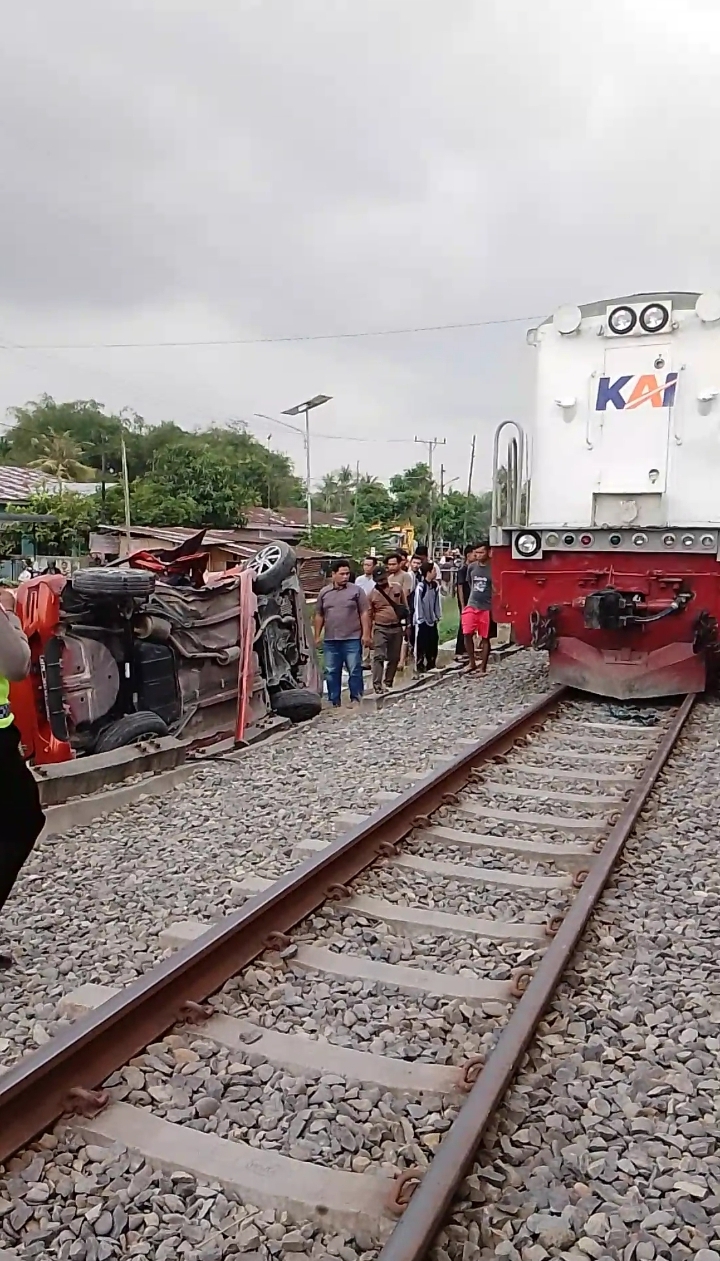TERBALIK:  Mobil Agya yang dikendarai korban terbalik usai ditabrak KA di pintu perlintasan Kereta Api tanpa plang, di Jalan Gunung Arjuna Kota Tebingtinggi