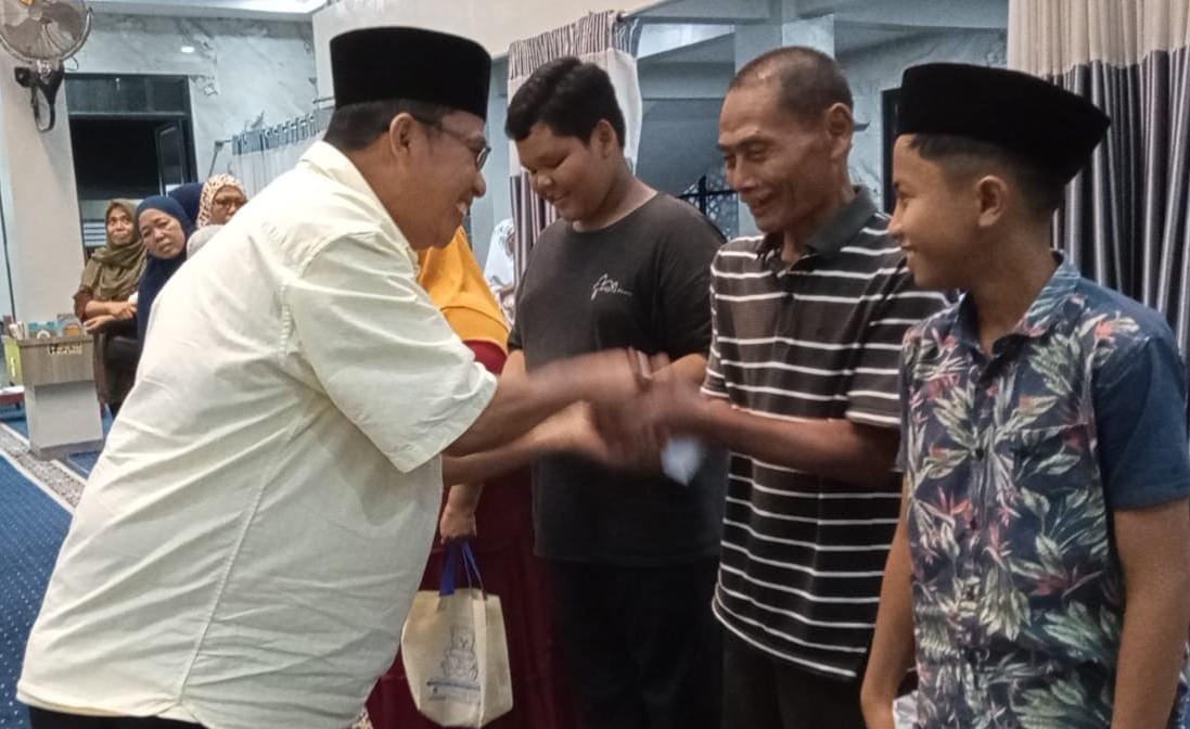 Ketua BKM Quathul Muslimin Drs Rivai Nasution MM menyerahkan santunan kepada duafa, anak yatim-piatu dan mualaf. (Dokumentasi BKM Quathul Muslimin)