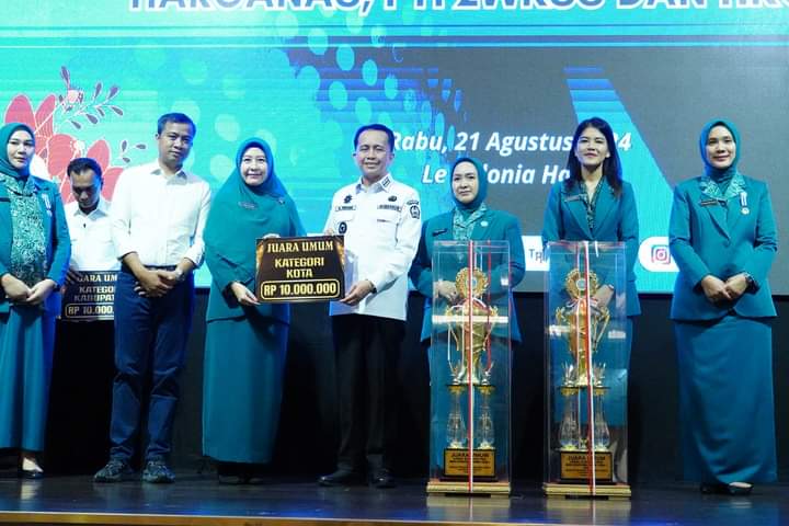 TERIMA: Pj Gubsu , Agus Fatoni didampingi Pj Ketua TP PKK Provinsi Sumut, Nyonya Tyas Fatoni menyerahkan hadiah kepada Pj Ketua TP PKK Kota Tebingtinggi, Nyonya Dara Caprina Moettaqien Hasrimi.