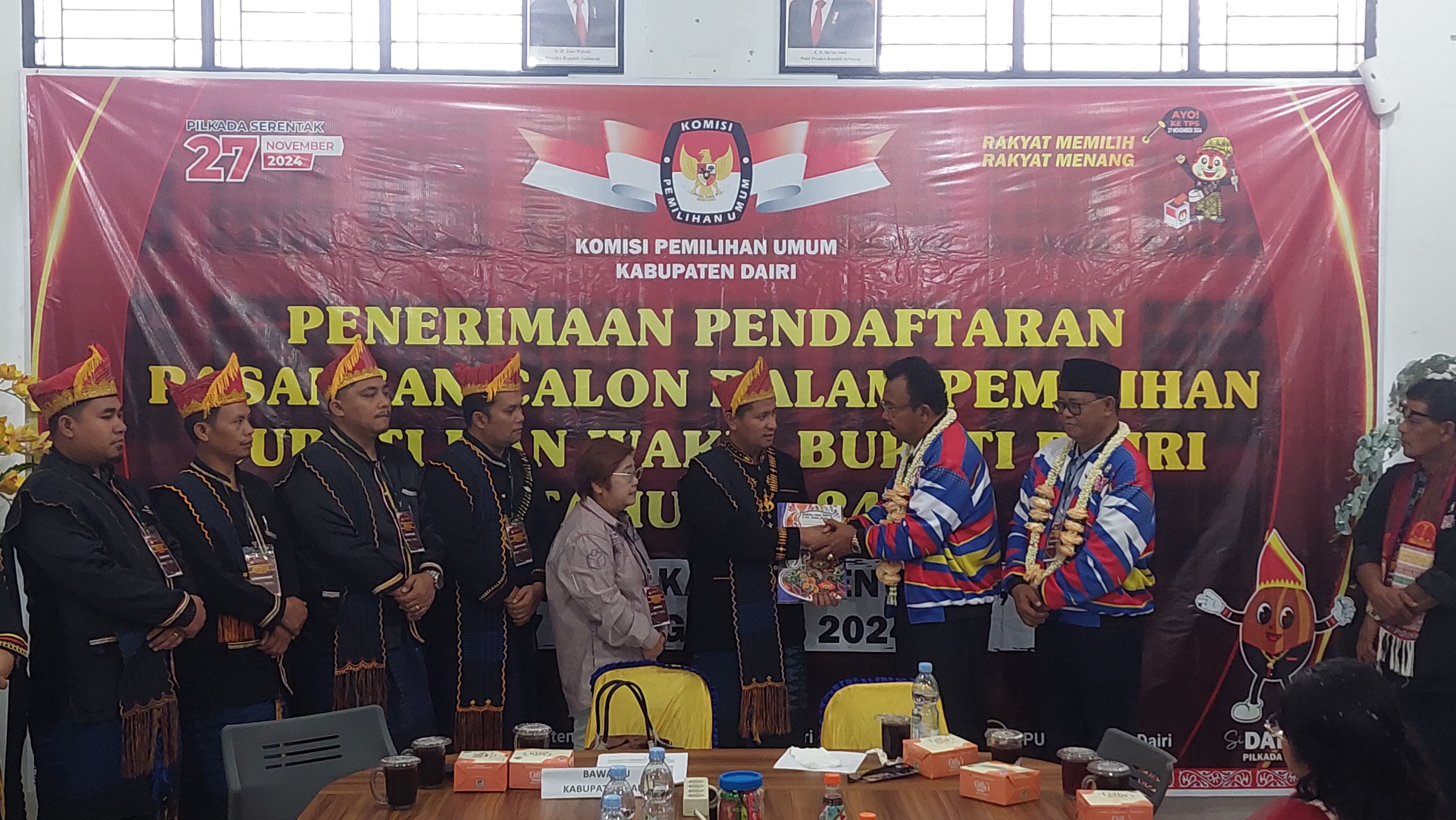 SERAHKAN BERKAS: Calon Bupati Dairi, Rimso Mauli Sinaga-Barita Sihite, menyerahkan berkas pendaftaran kepada Ketua KPU Dairi, Ariyanto Tinendung saat mendaftar di Kantor KPU, Selasa (27/8/2024).