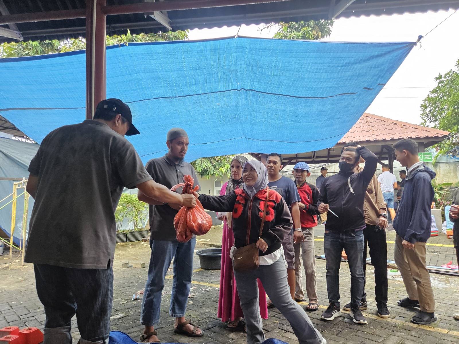 BAHAGIA: Kebahagiaan penerima qurban saat pengambilan daging qurban di halaman Mesjid Nurul Iman, Kantor PLN UID Sumatera Utara. FOTO: ISTIMEWA/SUMUT POS