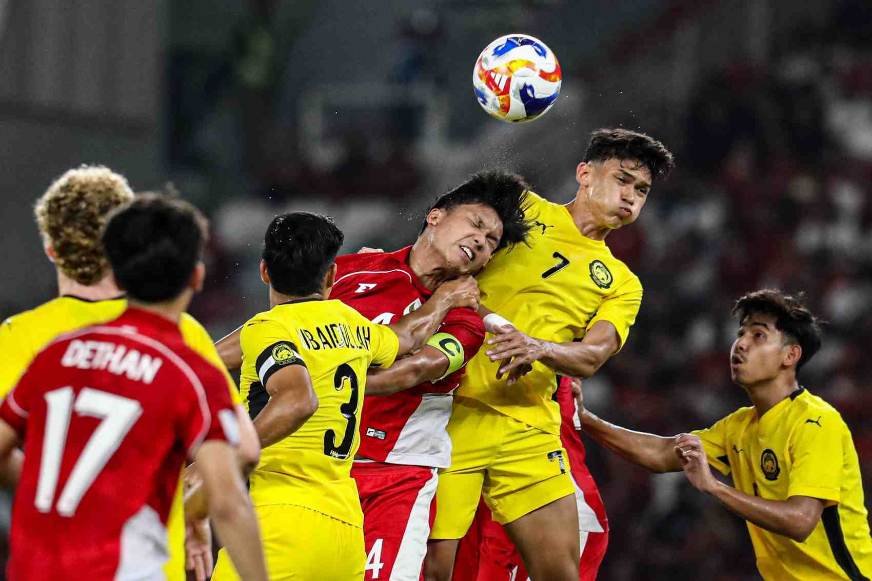 DUEL: Pesepak bola Timnas Indonesia U-23 duel di udara saat melawan Timnas Malaysia U 23 di babak penyisihan AFF.