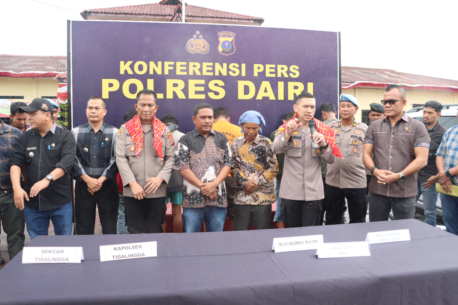 SEMATKAN. Kepala Desa Sarintonu, Irwan Tarigan dan tokoh masyarakat, Ngempat Angkat sematkan kain khas Suku Karo kepada Kapolres Dairi AKBP Otniel Siahaan dan Kapolsek Tigalingga.