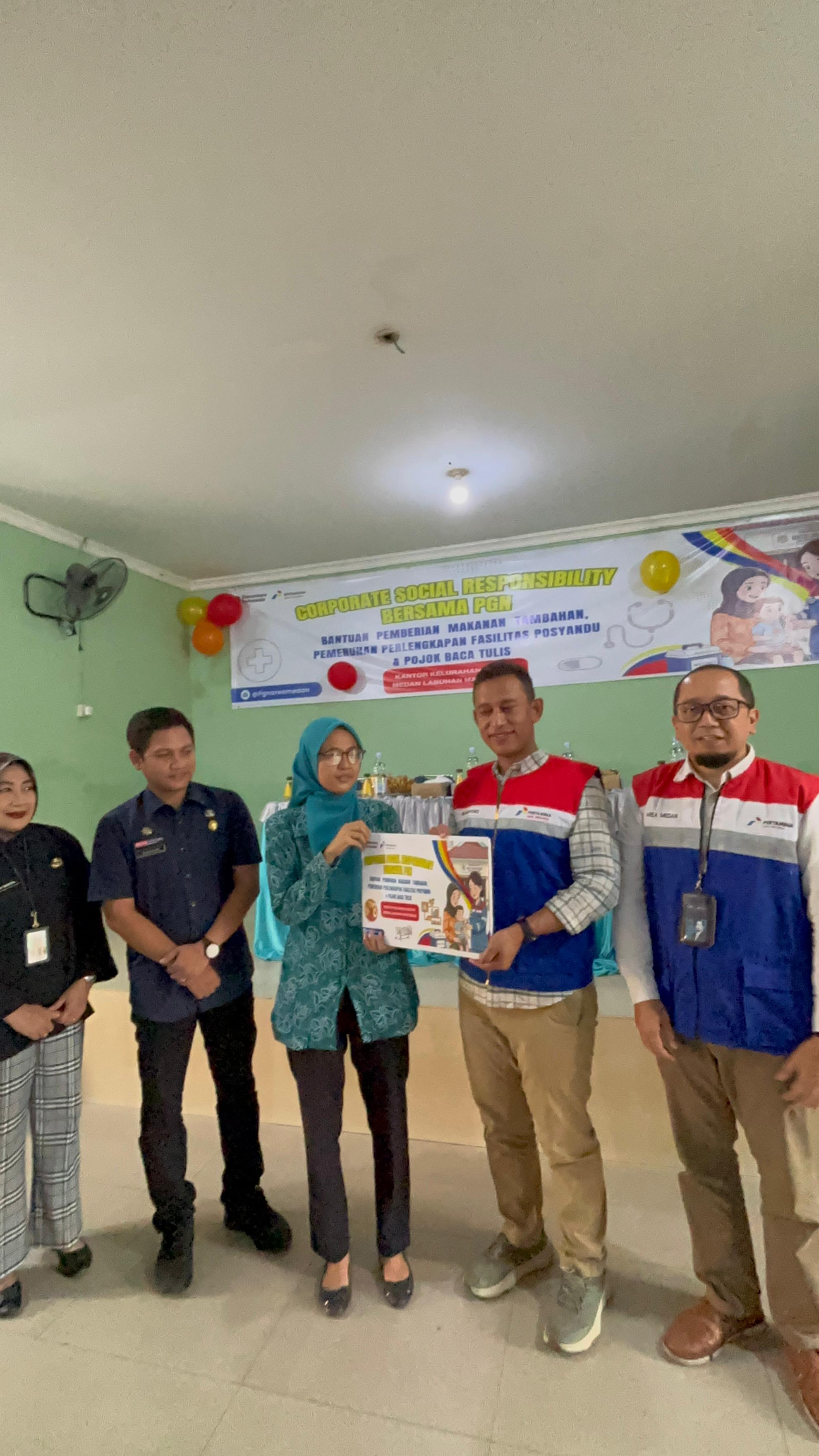 CSR: Ris Haryono, Division Head Regional Support and Services SOR I, bersama Agus Kurniawan selaku Area Head PGN Medan saat berikan CSR ke warga Martubung. (Dok: PGN)