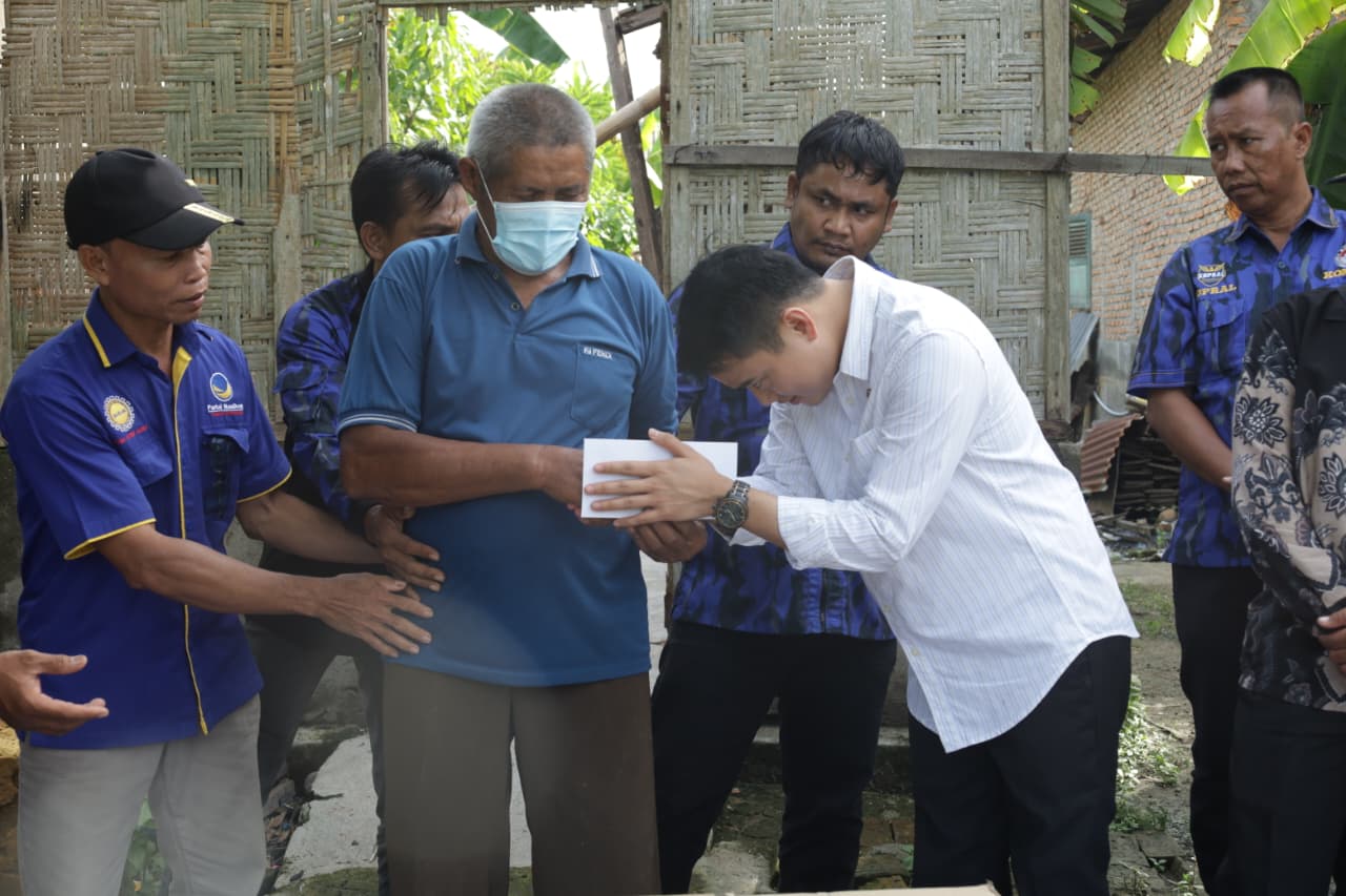 Wakil Ketua DPRD Sumut, Ricky Anthony saat memberikan tali asih kepada Ngadirun, korban kebakaran di Stabat. (Istimewa/Sumut Pos)