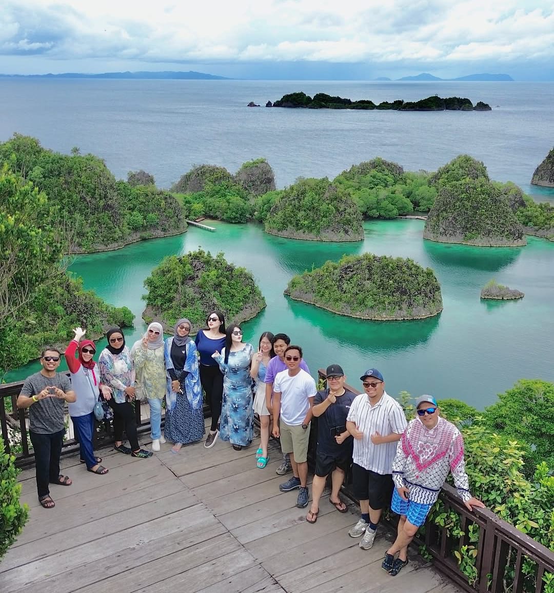 Para wisatawan swa foto dengan latar belakang keindahan pulau-pulau dan laut di Rajaampat. (instagram rajaampatexpert)