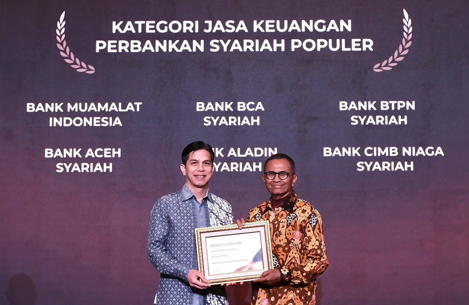 PIAGAM: Sekretaris Perusahaan PT Bank Muamalat Indonesia Tbk Hayunaji (kiri) menerima piagam penghargaan dari Founder Disway Dahlan Iskan di ajang Disway Awards 2025. (Dok: Bank Muamalat)