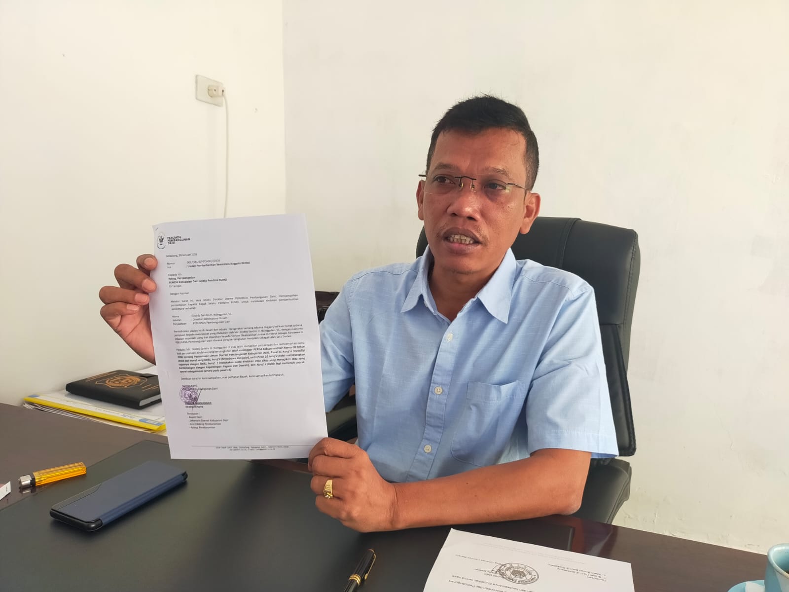 Direktur Utama Perumda Pembangunan Dairi, Tamrin Pandiangan menunjukkan surat usulan pemberhentian sementara anggota Direksi berinisial DSHN saat ditemui, Selasa (3/2). (RUDY SITANGGANG/SUMUT POS)