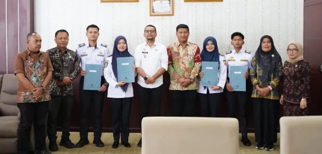 Bupati Fery Sahputra Simatupang foto bersama Lima CPNS lulusan Trasportasi Darat Indonesia usai menerima SK PNS. (KHAIRUDDIN/SUMUT POS)