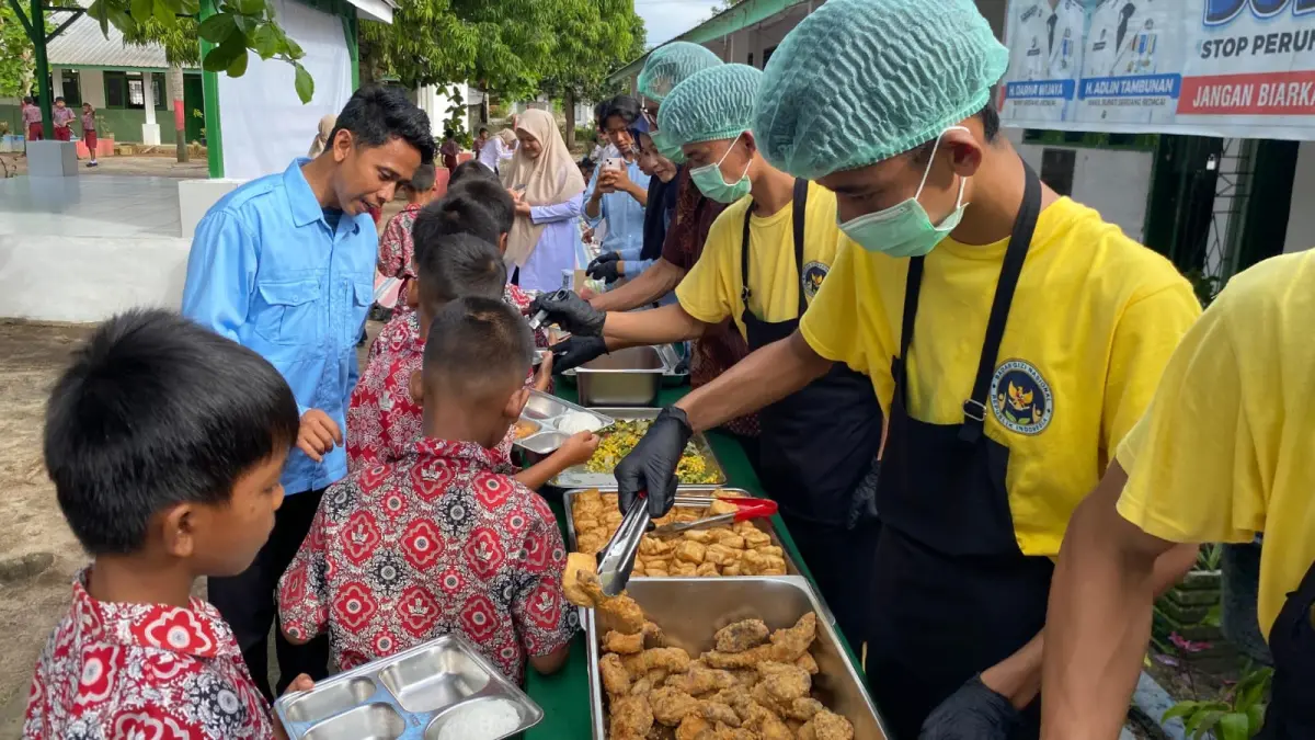 Petugas SPPG Firdaus I melayani siswa SDN 107967 Pelintahan saat pembagian Makanan Bergizi Gratis (MBG) dengan sistem prasmanan di Kecamatan Tanjung Beringin, Sergai, Rabu (8/4).( Fadly/ Sumut Pos)