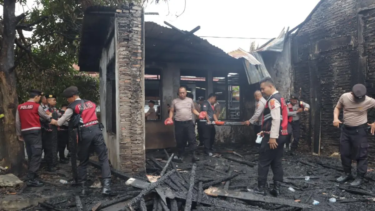 Personel Polres Labuhanbatu gotong royong membersihkan puing-puing pasca kebakaran di Jalan Bakti Lama, Rantauprapat (Fajar/Sumut Pos)