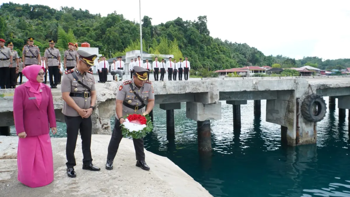 Kapolres Nias Selatan, AKBP Ferry Mulyana Sunarya, didampingi Wakapolres tabur bunga di Pelabuhan Baru Teluk Dalam. (Eriusman Duha/Sumut Pos)
